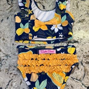 RuffleButts Navy and Orange Tropical Print 2pc Swimsuit